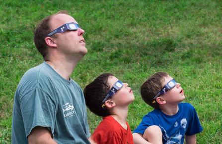 Family looking at solar eclipse
