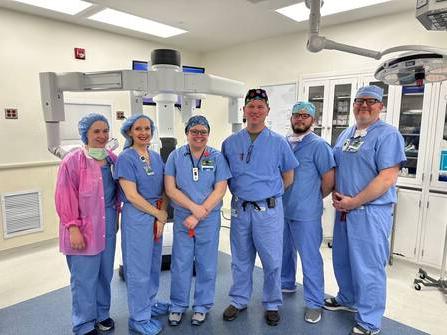 Photo of medical professionals with the robotic surgical platform